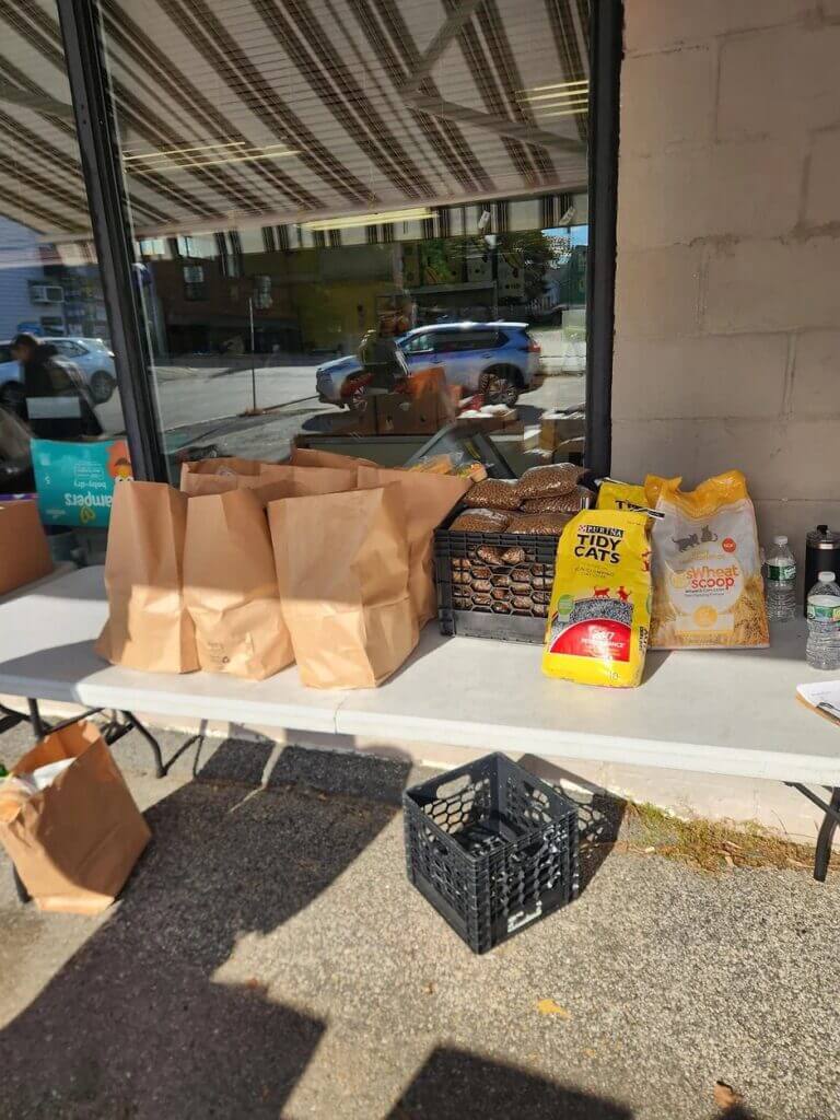 Items for clients at food pantry table in front of Biddeford Food Pantry